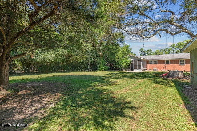 view of yard featuring a sunroom