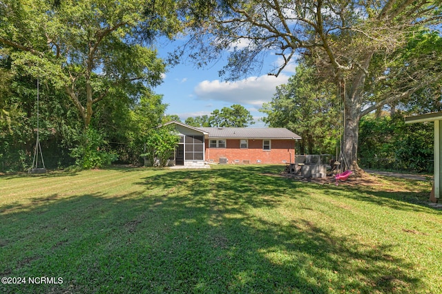 view of yard with a sunroom