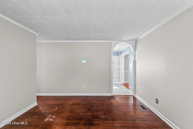 unfurnished room with ornamental molding, dark wood-type flooring, and a textured ceiling