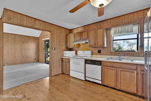 kitchen featuring light wood-type flooring, white appliances, sink, and a wealth of natural light