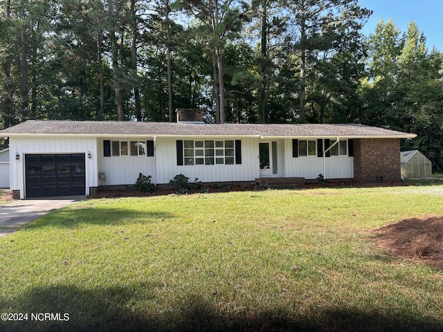 ranch-style house with a garage and a front lawn