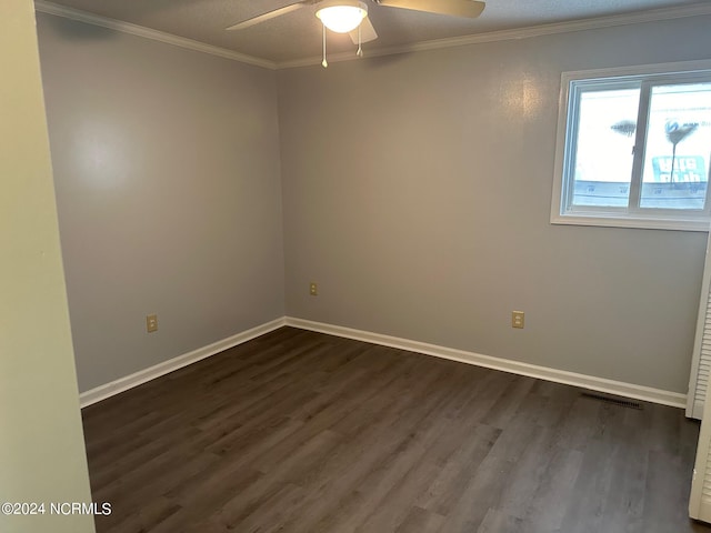 empty room with crown molding, ceiling fan, dark wood-type flooring, and a textured ceiling