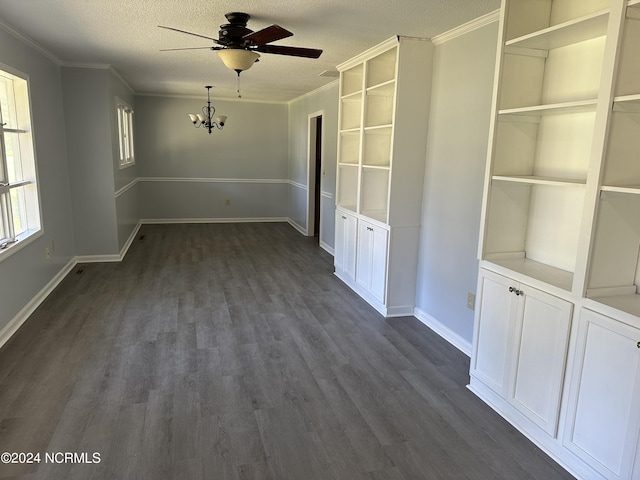 unfurnished dining area featuring ceiling fan with notable chandelier, crown molding, dark wood-type flooring, and a textured ceiling