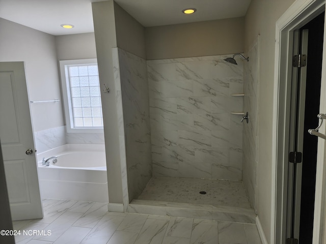 bathroom with separate shower and tub