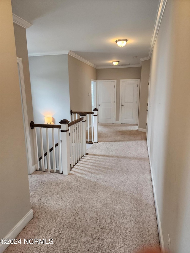 hall featuring light carpet and crown molding