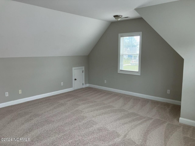 bonus room featuring light carpet and lofted ceiling