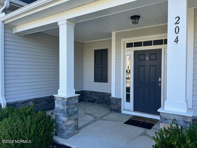 property entrance featuring covered porch