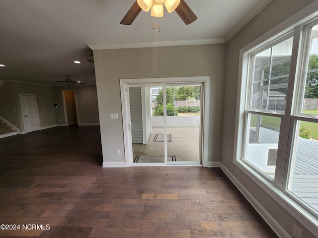 unfurnished room with ceiling fan, dark wood-type flooring, and crown molding