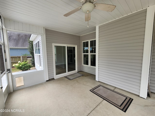 unfurnished sunroom with ceiling fan