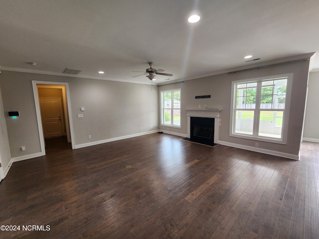 unfurnished living room featuring ceiling fan, crown molding, and dark wood-type flooring