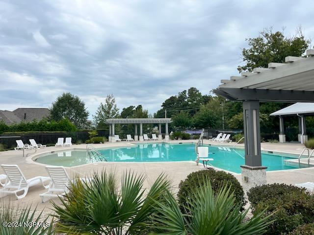 view of pool featuring a pergola and a patio area