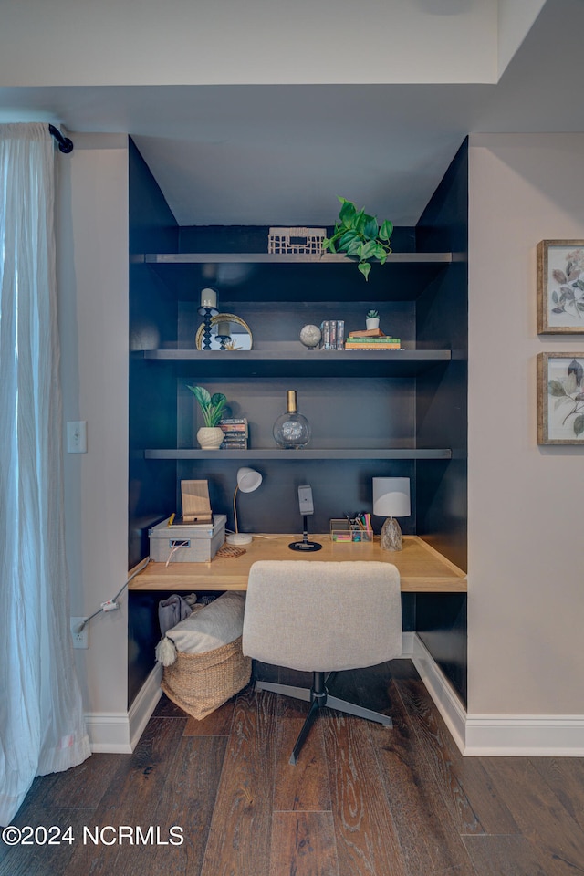 office space featuring dark hardwood / wood-style flooring and built in features