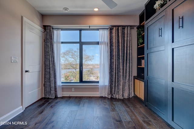 unfurnished bedroom featuring dark hardwood / wood-style floors and ceiling fan