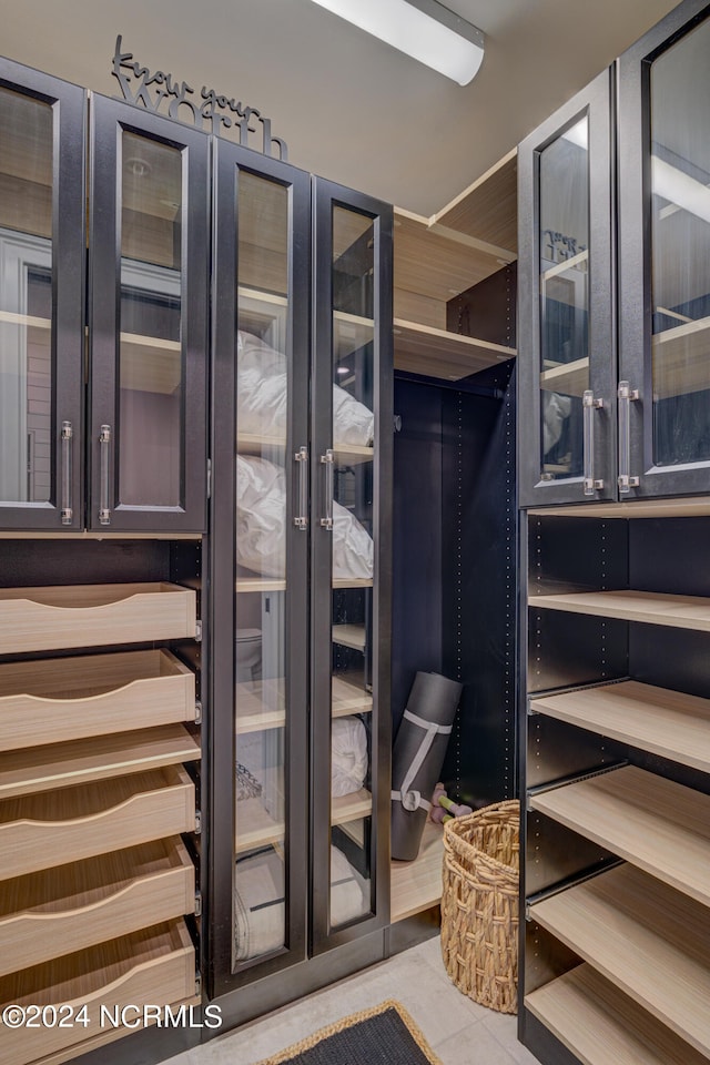 spacious closet featuring light tile patterned flooring