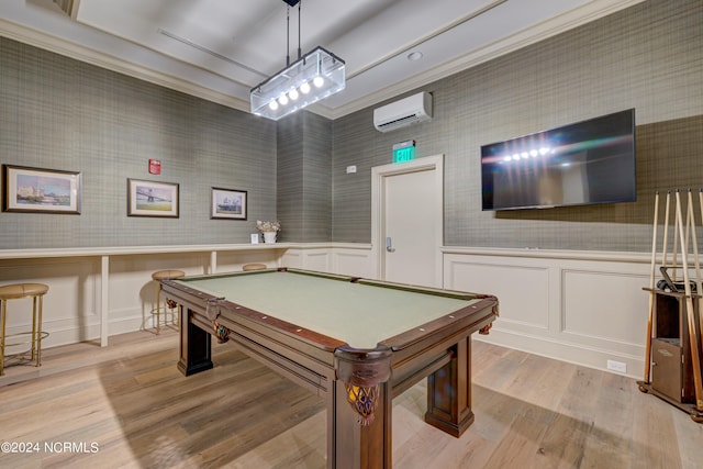 game room featuring light hardwood / wood-style floors, an AC wall unit, crown molding, and billiards