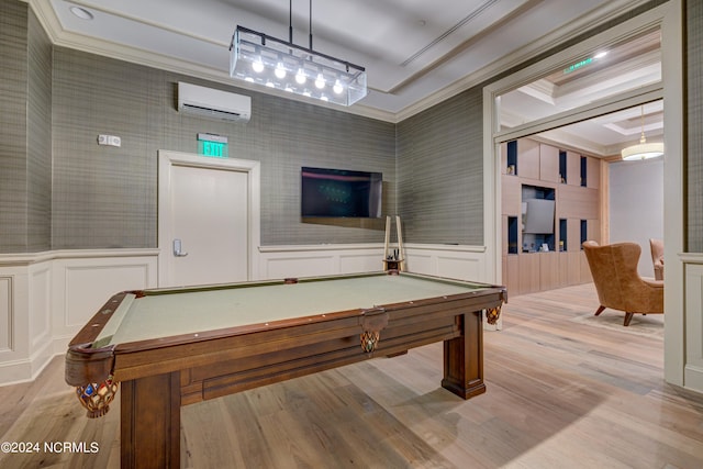 game room featuring crown molding, light wood-type flooring, a wall mounted air conditioner, and billiards