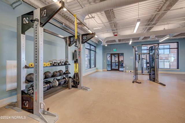 workout area with french doors and a healthy amount of sunlight