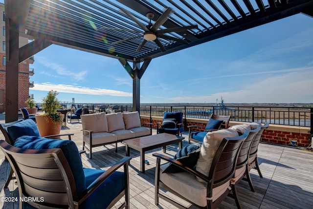 wooden terrace featuring an outdoor living space and ceiling fan