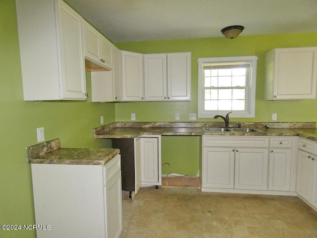 kitchen featuring sink and white cabinetry