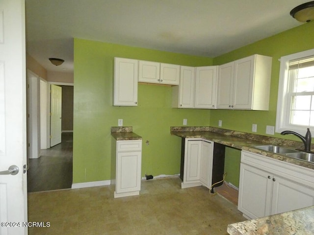 kitchen featuring white cabinetry and sink