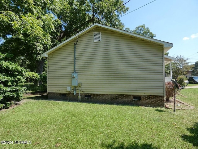 view of home's exterior featuring a lawn and crawl space