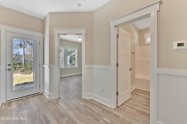 foyer entrance with light wood-type flooring and ceiling fan