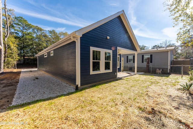 rear view of house with a lawn