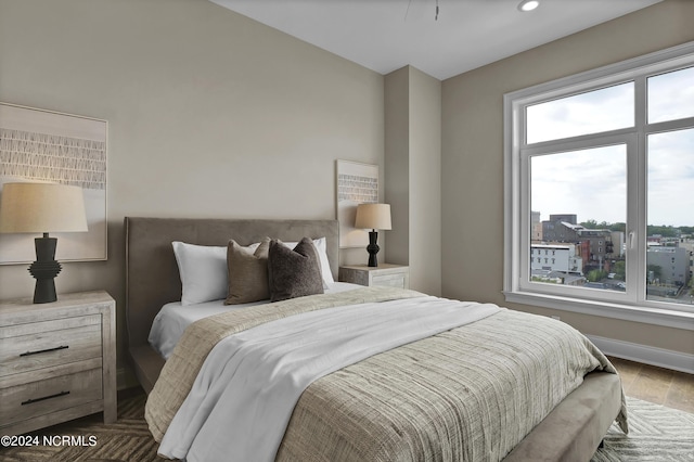 bedroom with baseboards and wood finished floors