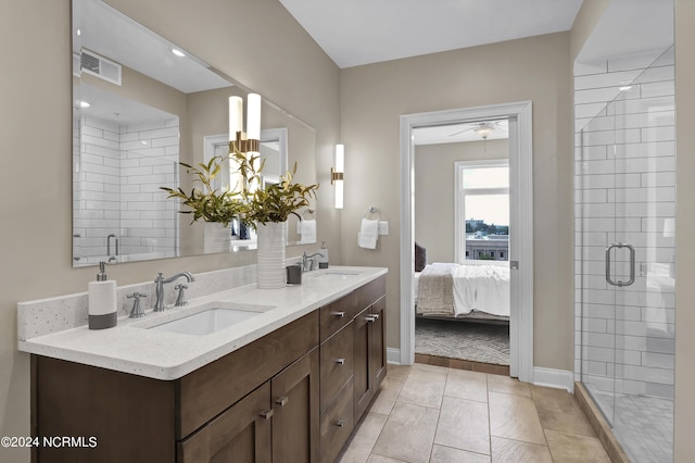 ensuite bathroom featuring visible vents, a sink, tile patterned floors, and a shower stall