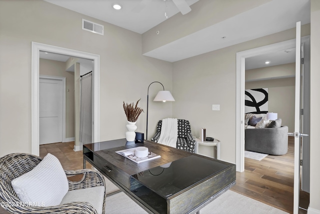 office area featuring ceiling fan, visible vents, recessed lighting, and wood finished floors