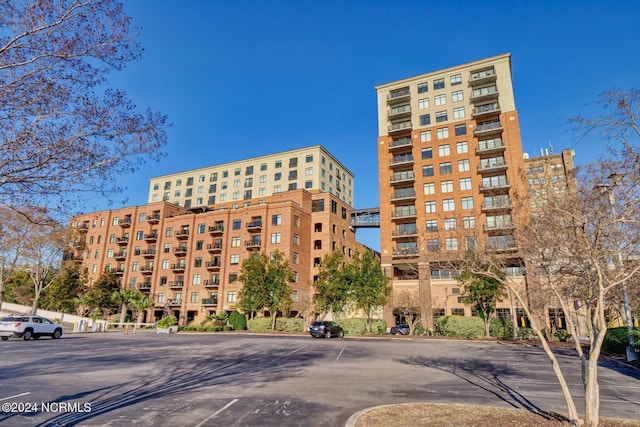 view of building exterior featuring uncovered parking