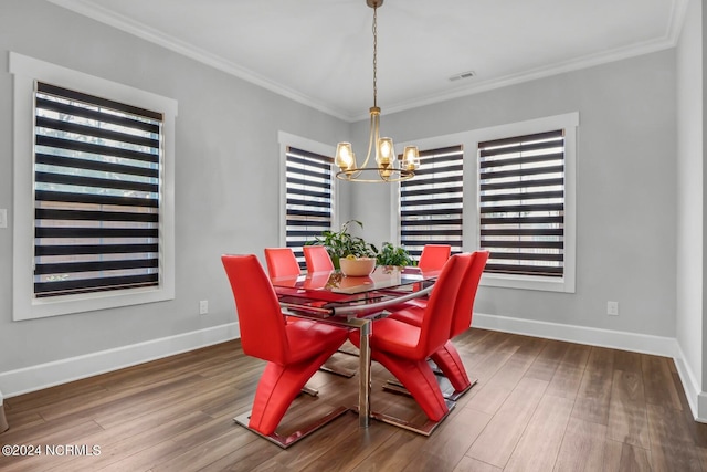 dining area with an inviting chandelier, hardwood / wood-style flooring, and crown molding