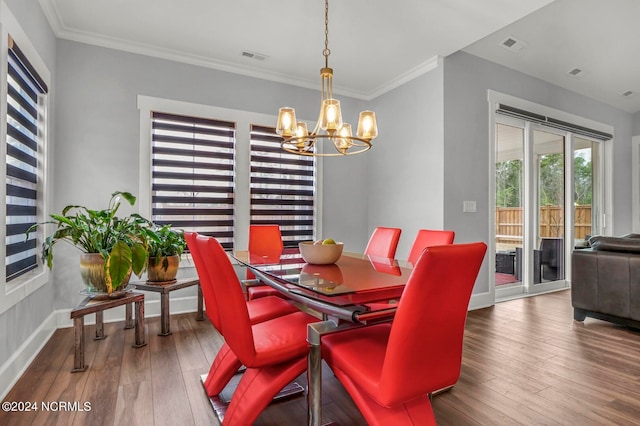 dining area with ornamental molding, an inviting chandelier, and wood-type flooring