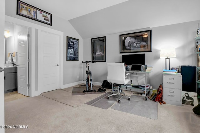 office space with lofted ceiling and light carpet