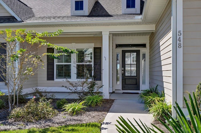 view of exterior entry with a porch