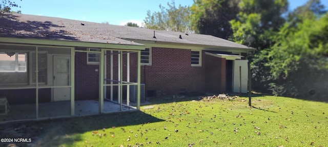 back of property featuring a lawn and a patio area