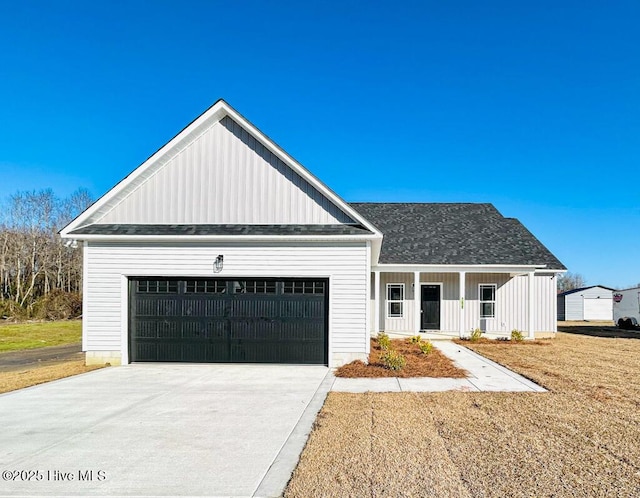 view of front of property with a porch and a garage