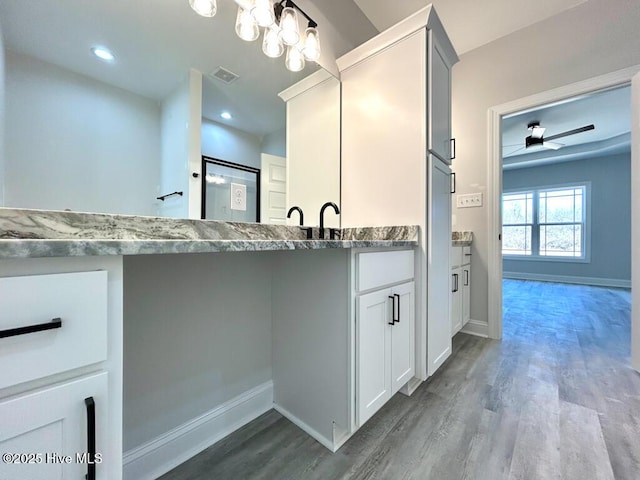 bathroom with ceiling fan, wood-type flooring, and vanity