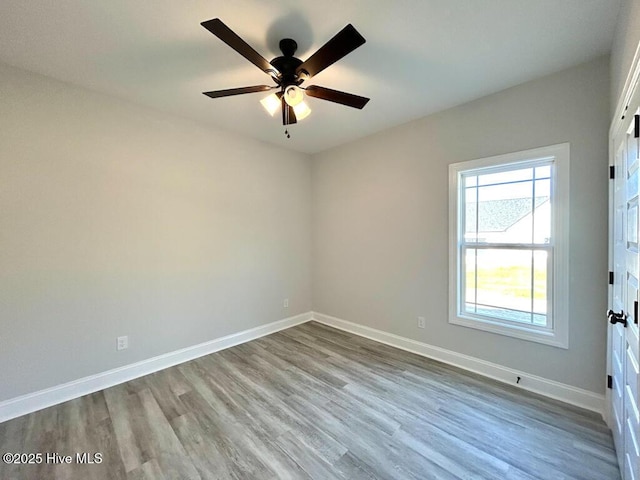 empty room featuring ceiling fan and light hardwood / wood-style floors