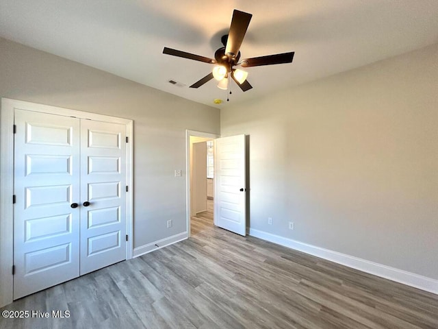 unfurnished bedroom featuring a closet, ceiling fan, and light hardwood / wood-style floors