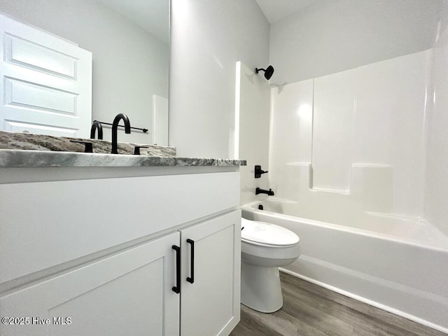 full bathroom featuring shower / tub combination, vanity, toilet, and wood-type flooring