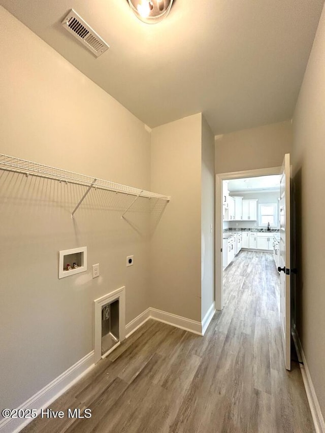 laundry area featuring hardwood / wood-style flooring, electric dryer hookup, and hookup for a washing machine