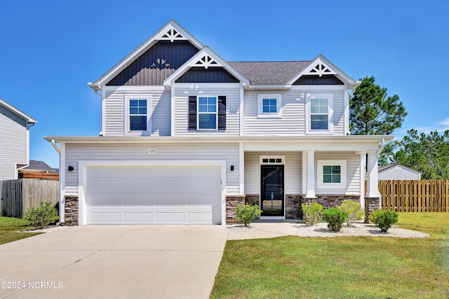 craftsman house featuring a front lawn, a garage, and covered porch