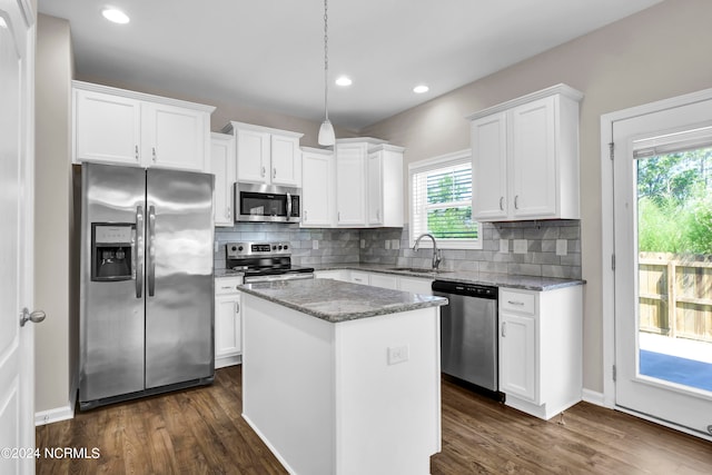 kitchen with appliances with stainless steel finishes, a wealth of natural light, white cabinetry, and sink