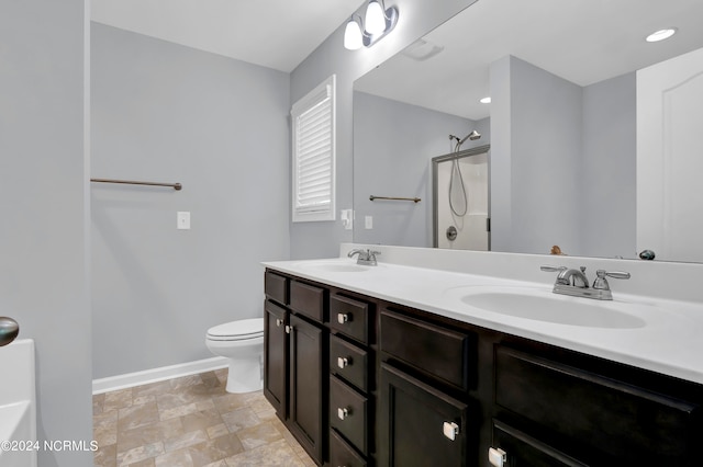 bathroom featuring vanity, toilet, and a shower