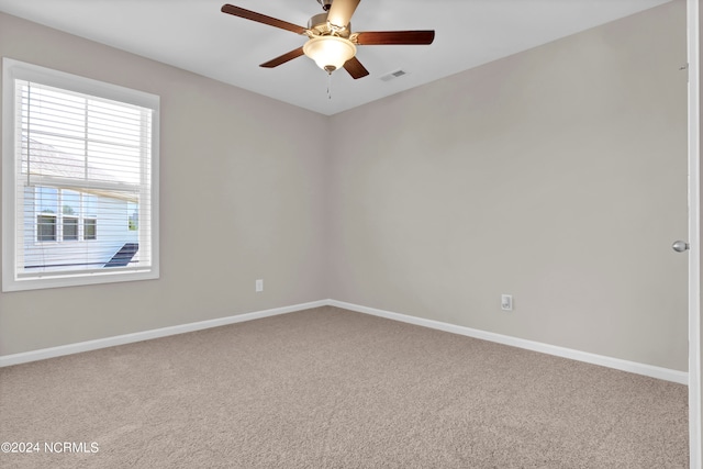 carpeted spare room with ceiling fan