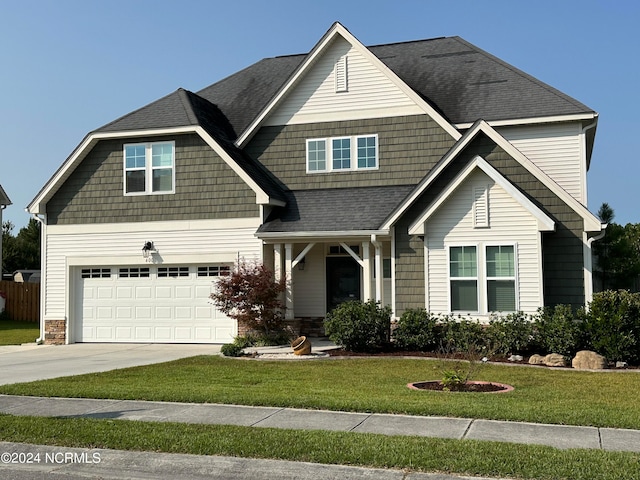 craftsman-style home with a garage and a front yard