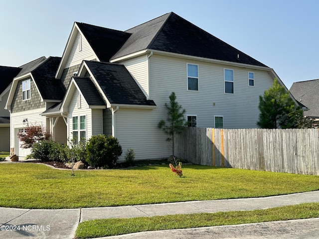 view of property exterior with a lawn