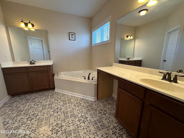 bathroom with a tub, tile patterned flooring, and vanity