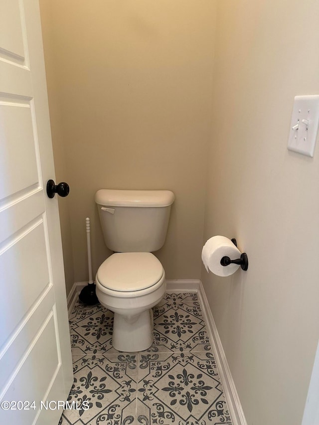 bathroom featuring tile patterned floors and toilet